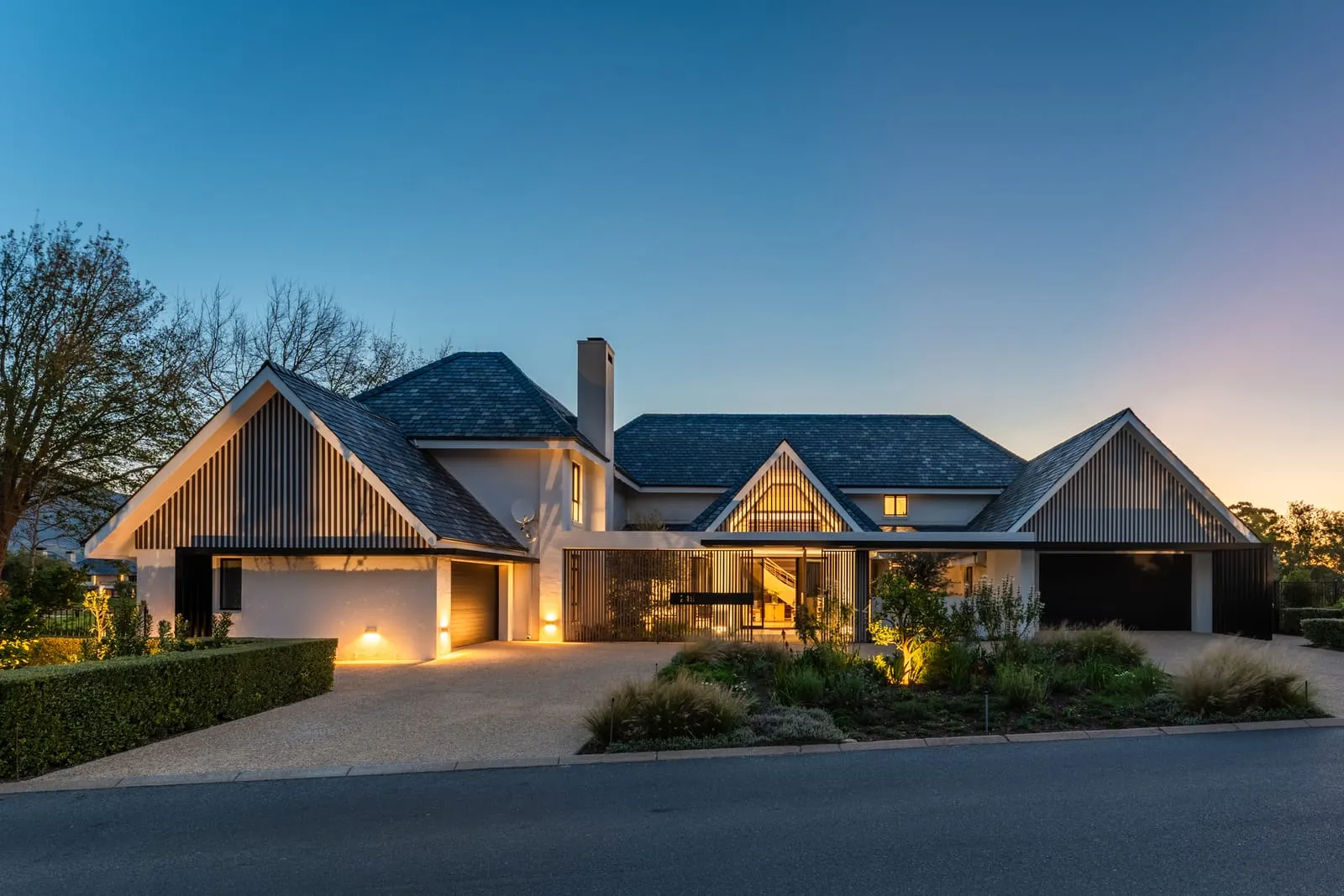 A modern family home lit up at twilight